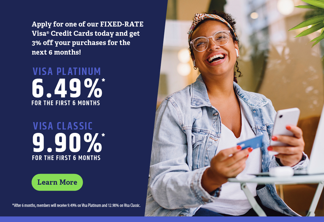 Woman smiles while holding a debit card and smart phone